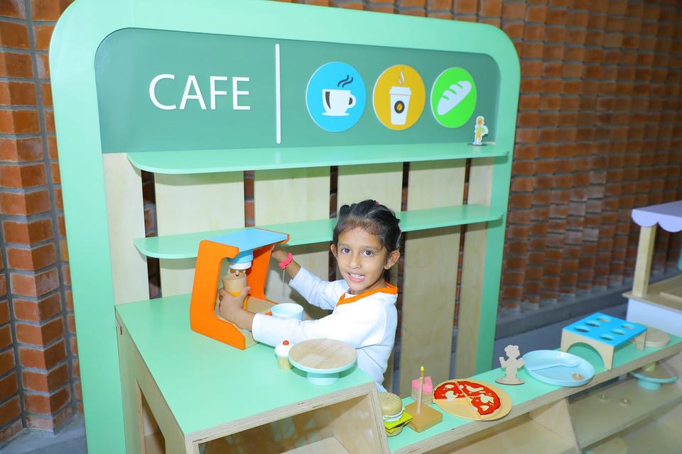 Child at the pretend cafe machine