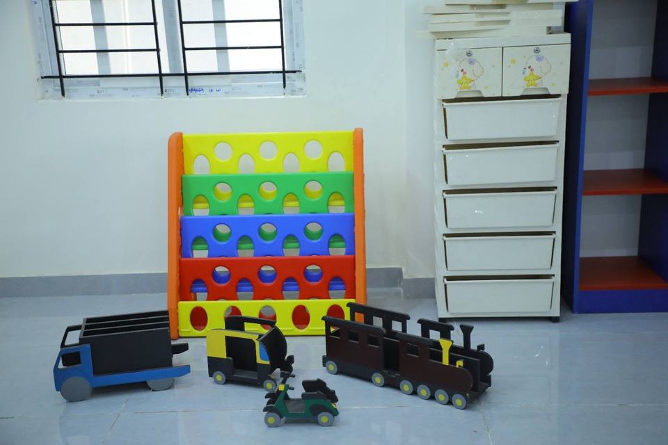 Wooden toy vehicles on shelf